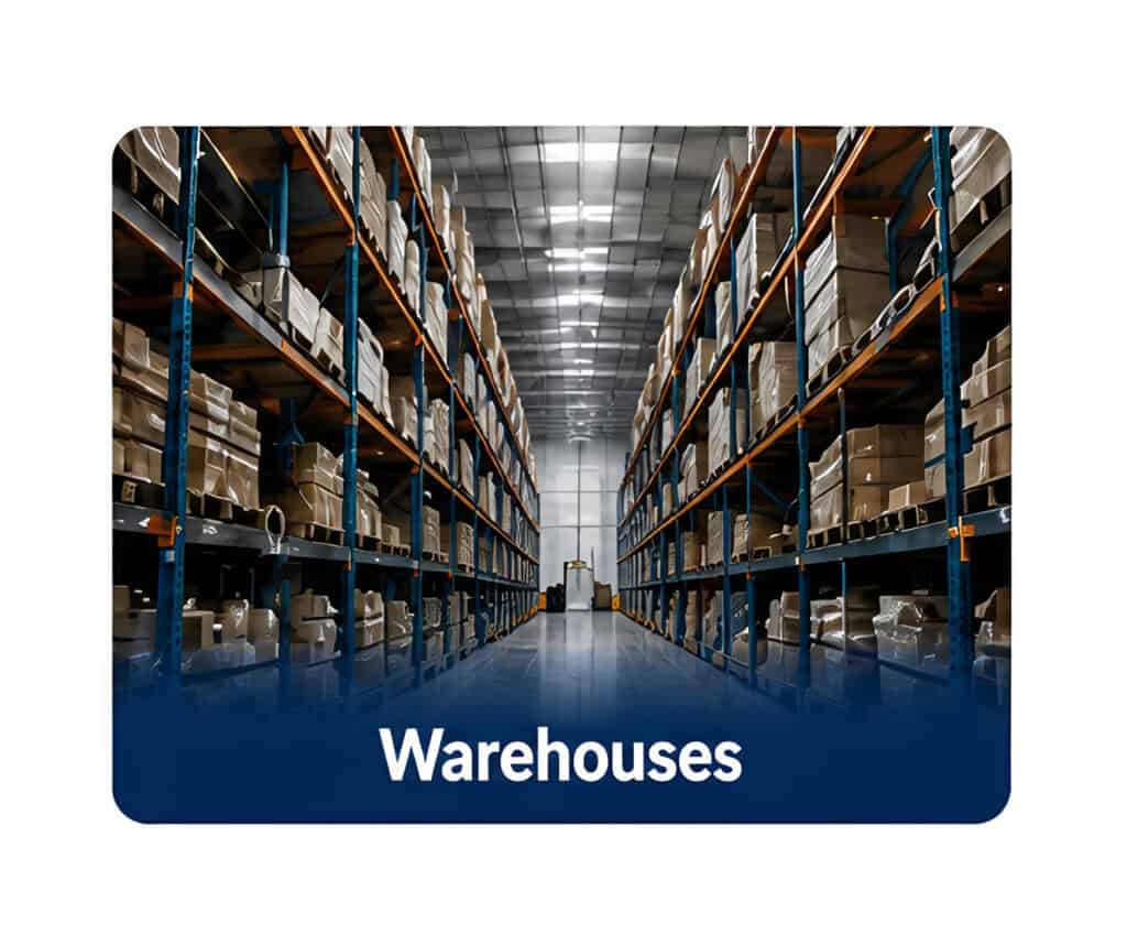 Long warehouse aisle with tall blue metal shelving on both sides, stacked boxes and pallets under bright overhead lights, viewed from a central perspective.